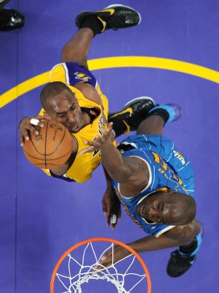 LA Lakers' Kobe Bryant dunks on New Orleans Hornets centre Emeka Okafor last night.