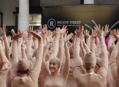 A giant human hand is formed by 200 in London's Covent Garden to visually illustrate Dupuytren's contracture, a progressive and debilitating hand condition.