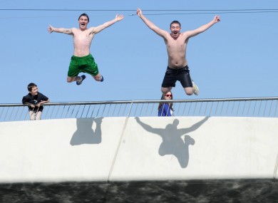 Michael Spain and Joseph McCarthy jump off Mayor Street Bridge in the IFSC into the River Liffey today