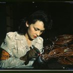 Original caption: Woman aircraft worker, Vega Aircraft Corporation, Burbank, Calif. Shown checking electrical assemblies. Photo: David Bransby