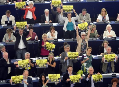 Green Party members of the European parliament demonstrate against the ACTA project during the vote