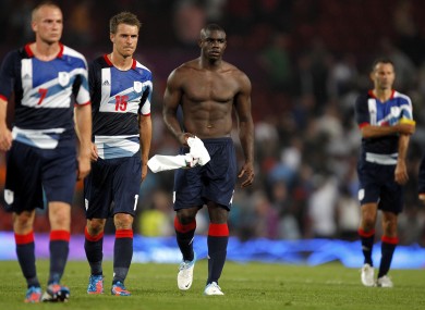 Great Britain's Tom Cleverley, Aaron Ramsey and Micah Richards are dejected after the game.