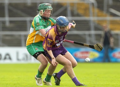 Wexford's Josie Dwyer holds off Triona McDonald of Offaly.