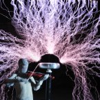 A man plays violin as up to 1 million volts, generated by a Tesla coil transformer, runs through his body during a stunt. Wang Zengxiang has dedicated himself to a dare-devil career for a decade. (Photo by Liu Tao/ChinaFotoPress)