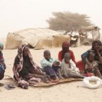 Standing outside their home in Andrabad village, northern Chad, with their supply of food for the forseeable future, are Etta Brahim Senussi (36, pictured right) and her children (L-R), Saleh Mahamad (7), Moussa Mahamed (5), Mohamed Ali (2) and Fatima Moussa (2). Her sister Fatima Senussi is pictured to the left, with neighbour Zeneba Louki. Image: Andy Hall/Oxfam