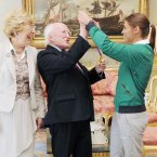 Katie tried to put her medal on to the President but he refused and put it back around her neck. Photo: Laura Hutton/Photocall Ireland