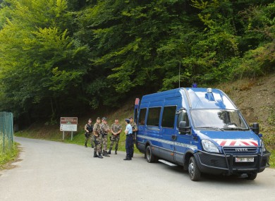 French police guard the road to the murder scene.