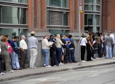 Members of the public queue outside the Social Welfare office in Bishops Square in Dublin's inner city