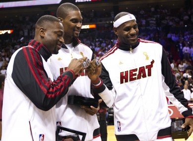 Dwayne Wade, Chris Bosh and LeBron James with their NBA championship rings.