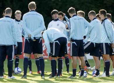 German coach Joachim Loew center, adresses his players during a training session yesterday.