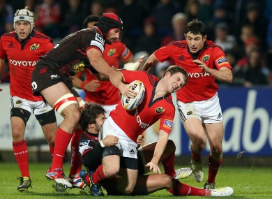 Munster's Luke O'Dea tackled by Gareth Owen of Scarlets.