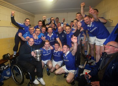 Thurles Sarsfields' players celebrate with the Bob O'Neill cup in the dressing-room after the game.