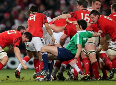 Referee Pascal Gauzere takes a tumble as Munster grind forward.