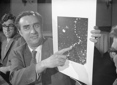 University of Chicago Physics Professor Albert V. Crewe points to a photograph which enables a single atom to be seen within a molecular structure for the first time. Enlarged 5 million times are thorium chains