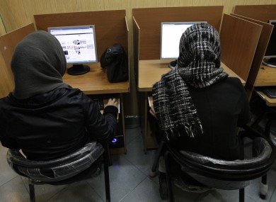 ranian women use computers at an Internet cafe in central Tehran, Iran