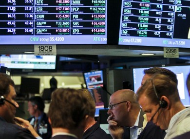 Traders at the New York Stock Exchange watch.