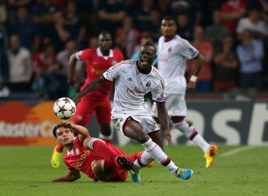 SV Eindhoven's Karim Rekik (left) tackles AC Milan's Mario Balotelli.