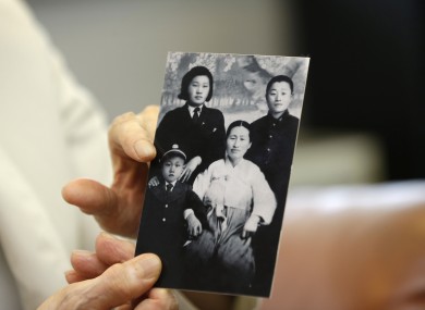 South Korean man Cho Il Woong, 81, shows his family photo in North Korea.