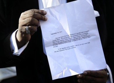 Bishop Gerald Seabrooks shows a statement made by Cathleen Alexis, mother of Washington Navy Yard gunman Aaron Alexis, in New York's Brooklyn borough on Wednesday