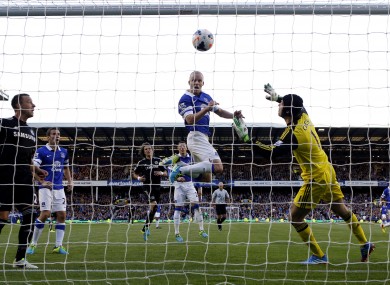 Everton's Steven Naismith scores past Chelsea's goalkeeper Petr Cech.