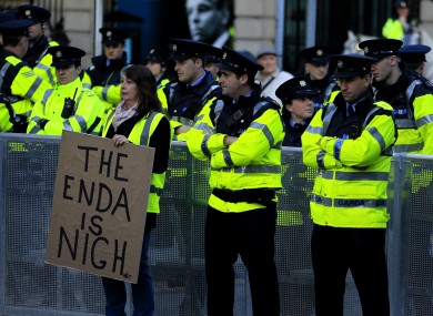 A protester with Garda outside Leinster House earlier.