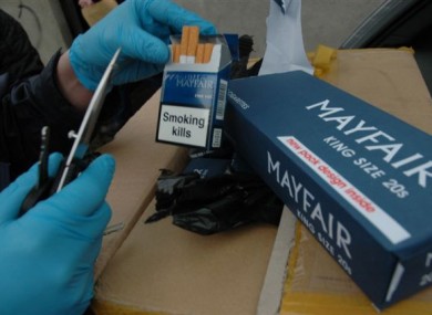File: Revenue staff with seized cigarettes